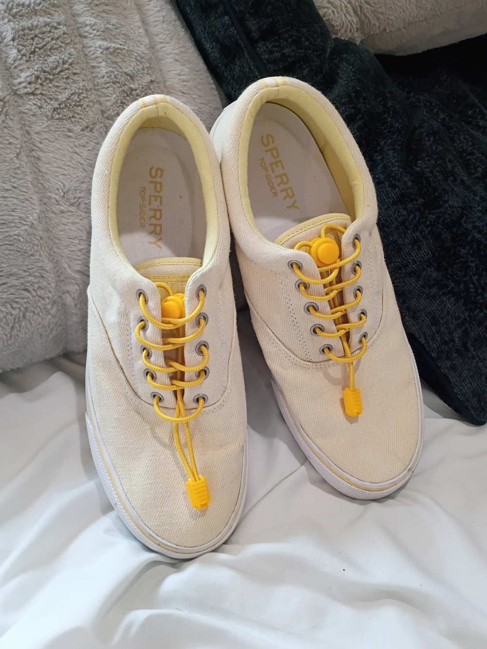 Yellow-tinged cream canvas sneakers are the Sperry Striper II CVO low-tops Sz 10